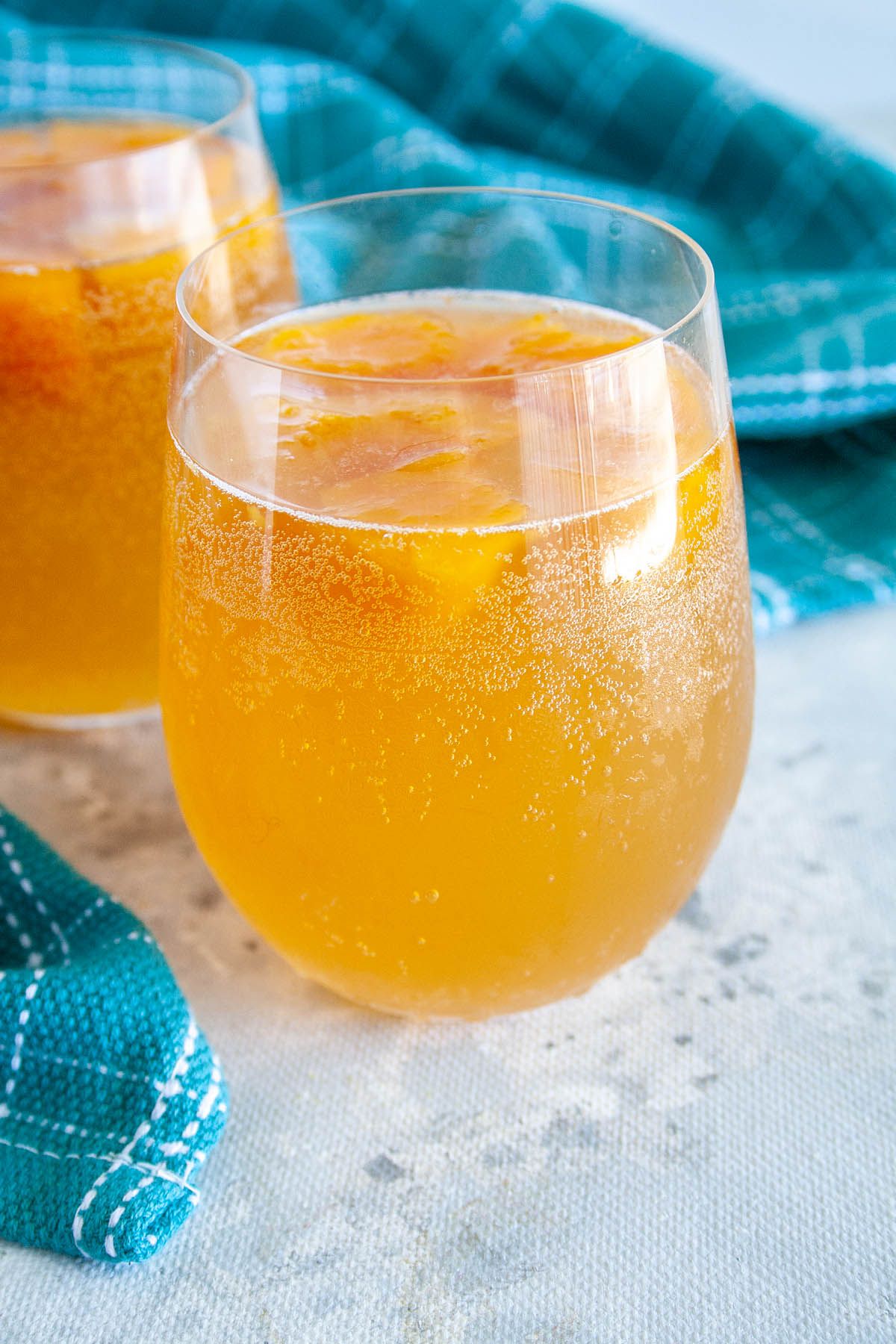 Two glasses of sparkling kombucha with fresh fruit